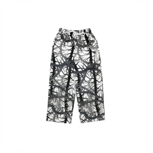 Loose-fitting pants with gray and black abstract geometric design.